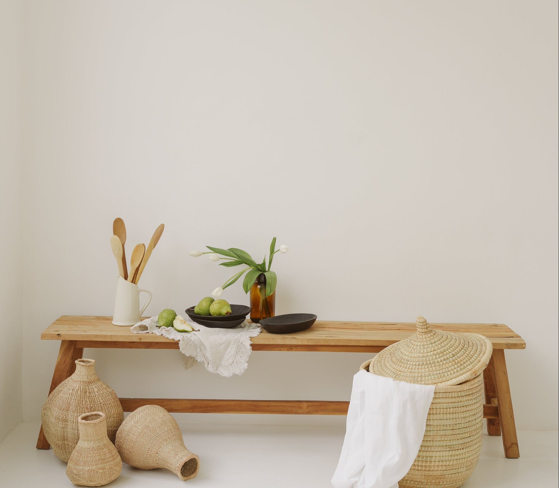 Wooden bench with decorative items against a plain wall